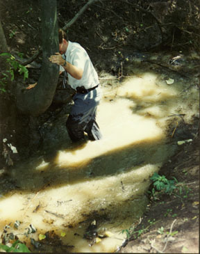 Detective Allen entering the creek